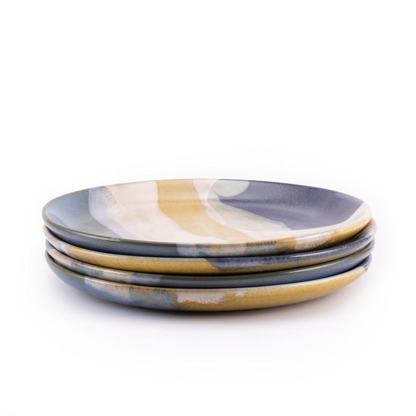 Tofino dinner plates, featuring a layering of multiple gorgeous reactive glazes on the plating area, stack of 4 plates in side shot.