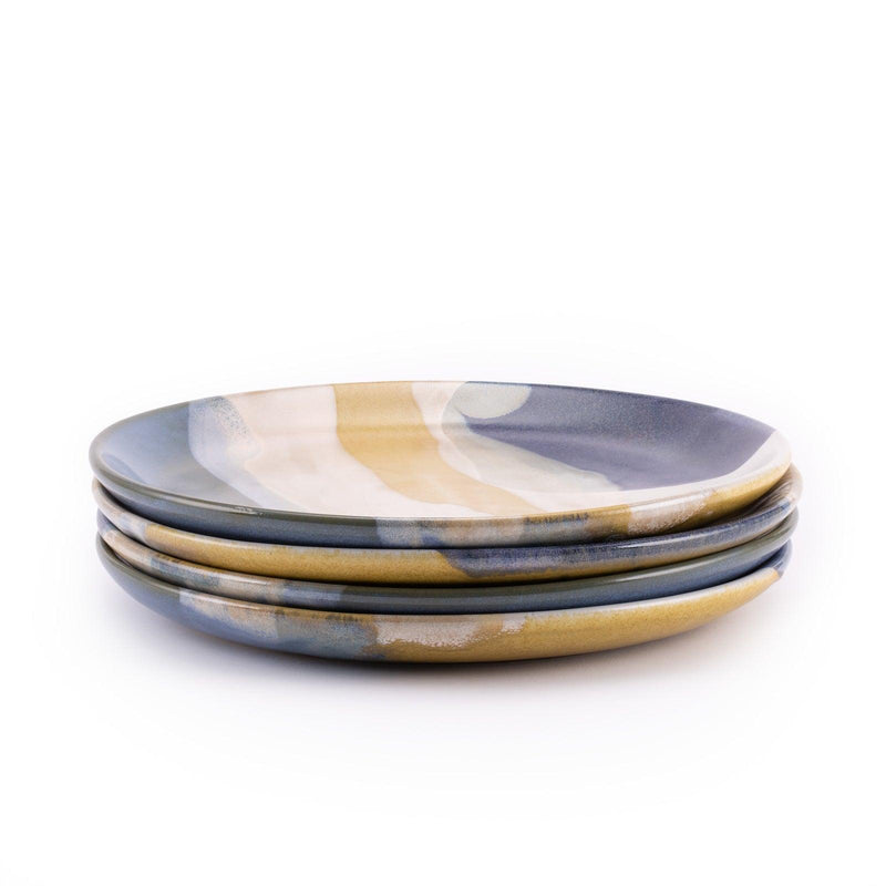 Tofino dinner plates, featuring a layering of multiple gorgeous reactive glazes on the plating area, stack of 4 plates in side shot.